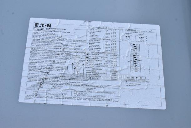 Electrical specifications label on a Cruising Kitchens mobile kitchen trailer indicating wiring details, breaker capacities, and model numbers.