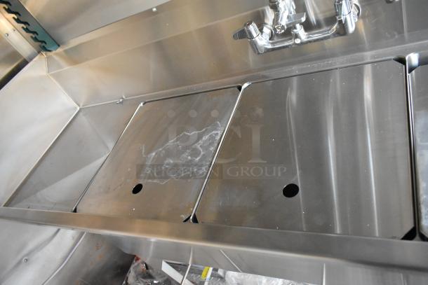 Three-compartment stainless steel sink in a new 2021 Cruising Kitchens Burger King fast food trailer.