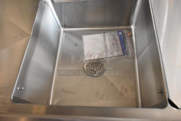 Stainless steel sink in a brand new Cruising Kitchens 2021 food trailer, featuring an Ecolab instruction packet.