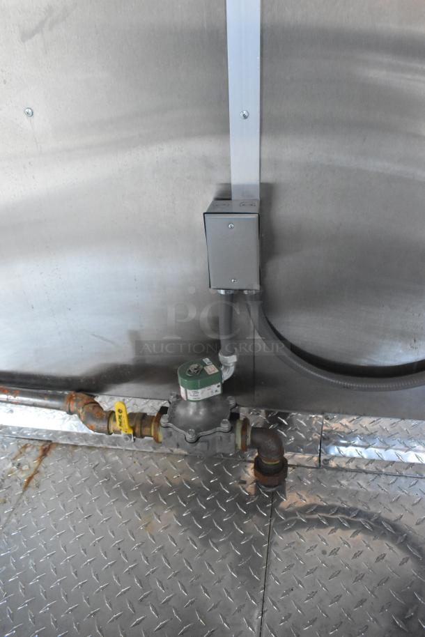 Interior of 2021 Cruising Kitchens Burger King fast food trailer with industrial piping and diamond-plate flooring.