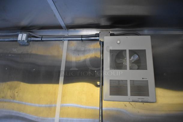 Interior view of a 2021 Cruising Kitchens 24' Burger King fast food trailer. Features visible wiring and a ventilation unit.