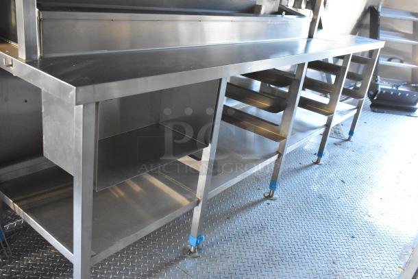 Brand new 2021 Cruising Kitchens 24' food trailer interior with stainless steel commercial kitchen equipment and storage.