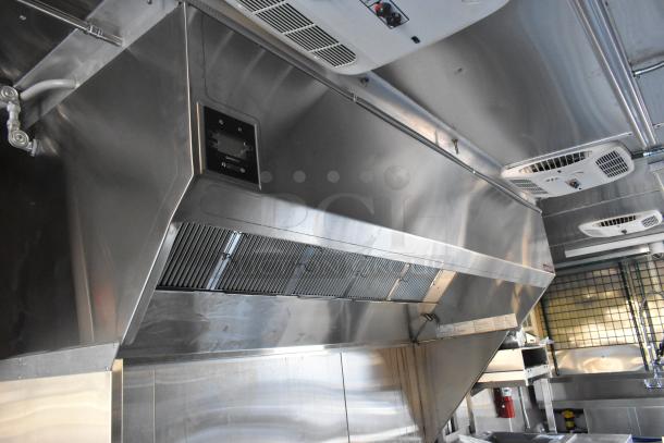 Interior of a brand new 2021 Cruising Kitchens 24' Burger King mobile kitchen trailer, featuring commercial-grade CaptiveAire grease hood and fire suppression system.
