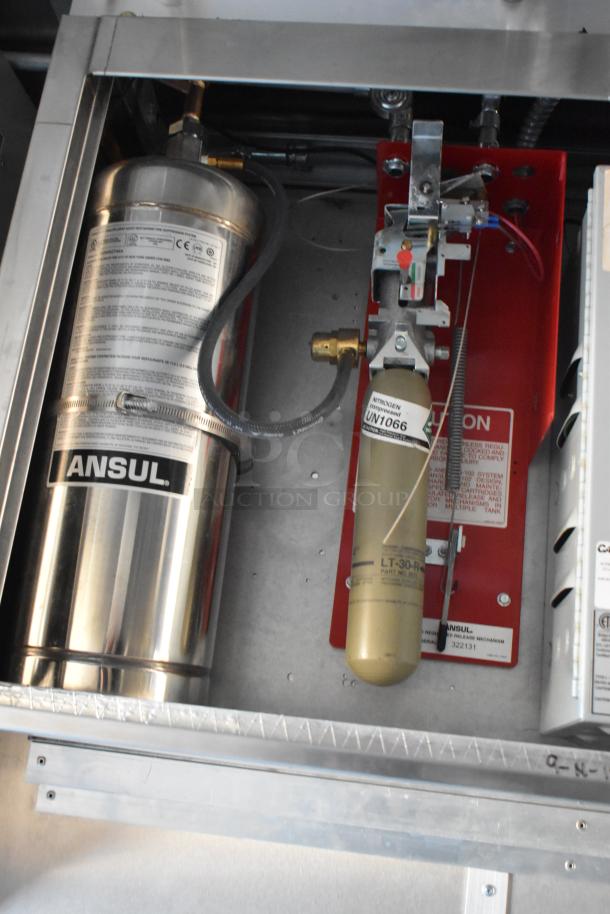 Interior view of a new 2021 Cruising Kitchens 24' Burger King Mobile Kitchen showing Ansul fire suppression system components.