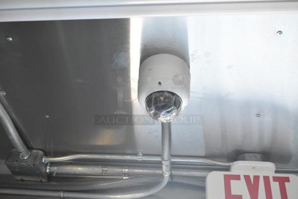 Interior view of 2021 Cruising Kitchens 24' Burger King fast food trailer. Visible are exit sign, electrical wiring, and a ceiling-mounted fixture.