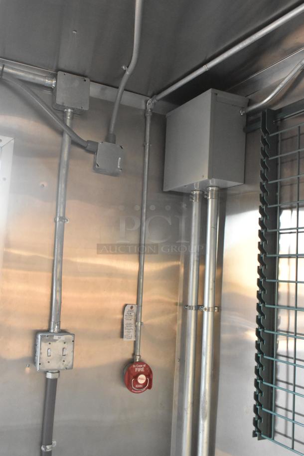 Interior view of 2021 Cruising Kitchens Burger King fast food trailer showing electrical fixtures and fire suppression pull station.