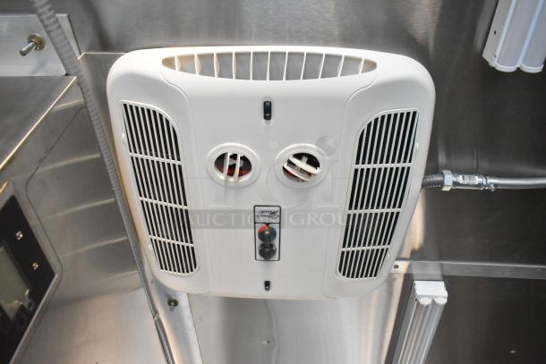 Interior view of a 2021 Cruising Kitchens 24' mobile kitchen with a commercial-grade ventilation system.