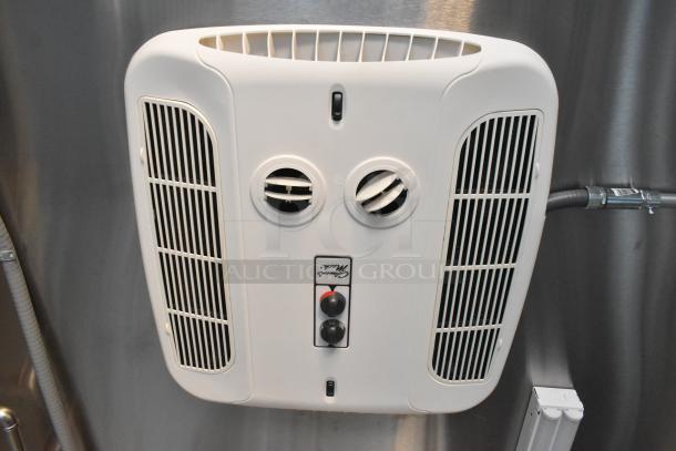 Wall-mounted air vent in Cruising Kitchens fast food trailer, featuring adjustable vents and control knobs, in new condition.