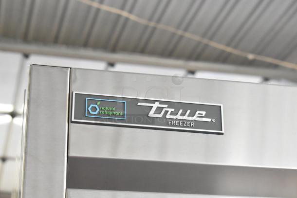 Brand new True T-23F-2-HC-MC commercial freezer, stainless steel, natural refrigerant label shown.