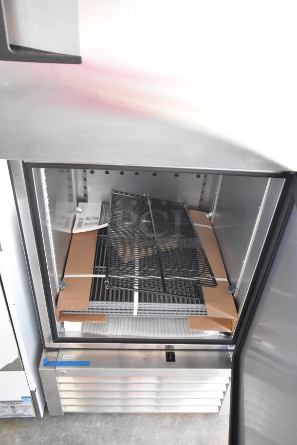 Brand new 2021 True T-23F-2-HC-MC commercial freezer, two half-size doors, poly-coated racks, 115 volts, 1 phase, visible scratch.