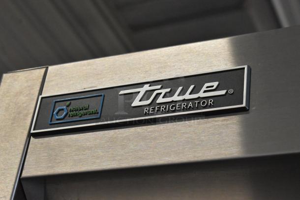 Brand new True T-23-2-HC commercial cooler, 2 half-size doors, poly-coated racks, 115V, natural refrigerant label visible.