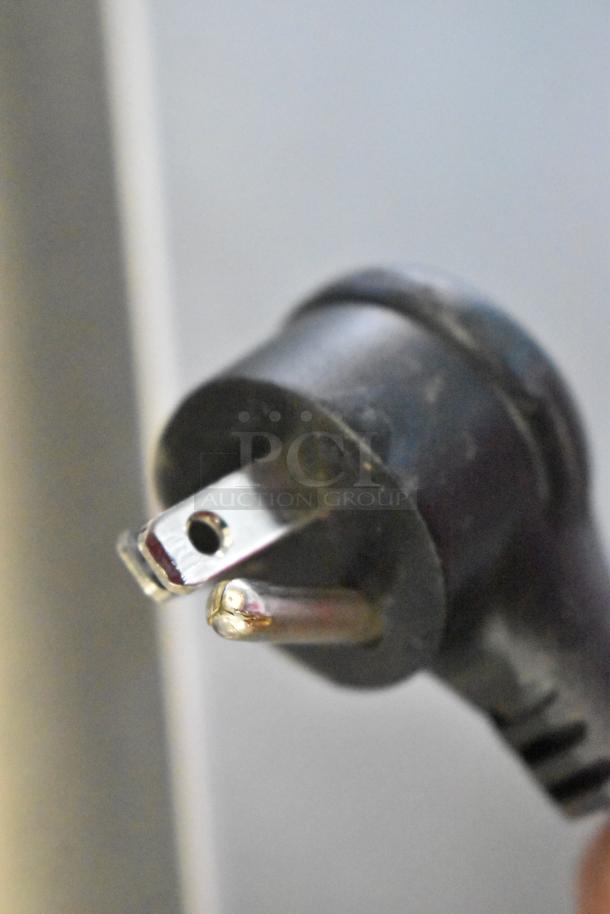 Close-up of a power plug, likely part of the True T-23-2-HC reach-in cooler's electrical system, 115 volts, 1 phase.