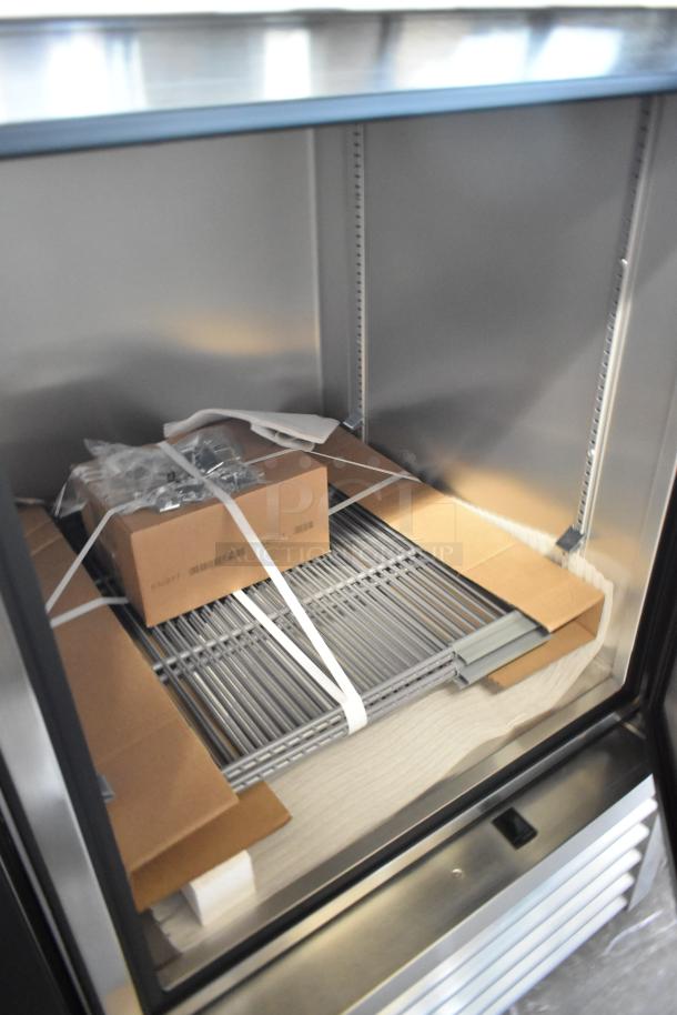 New 2021 True T-23-2-HC commercial cooler, two half doors, poly-coated racks, minor scratches, includes packaging, 115V, 1 Phase.