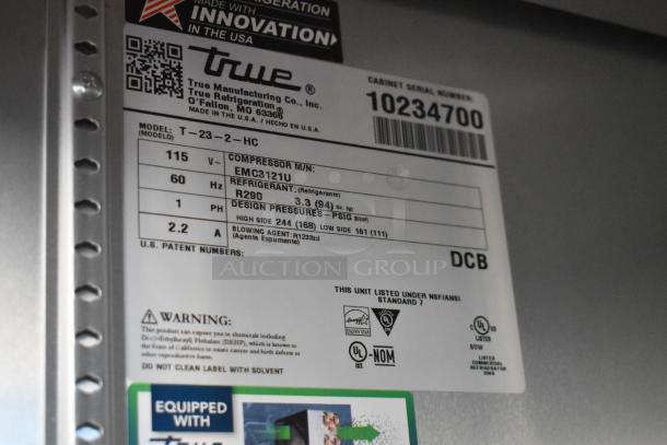 Label detailing specifications for True T-23-2-HC cooler, including voltage, refrigerant type, and compliance standards.