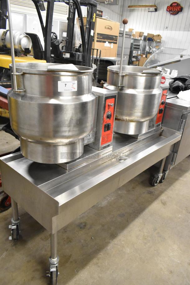 Vulcan steam table station with 2 K12ETT 12-gallon tilting kettles on casters, stainless steel, 208/240V, 3/1 phase.