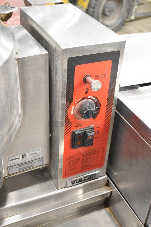 Vulcan steam table station with two 2016 K12ETT 12-gallon tilting kettles, featuring temperature controls and tilt lock handle.