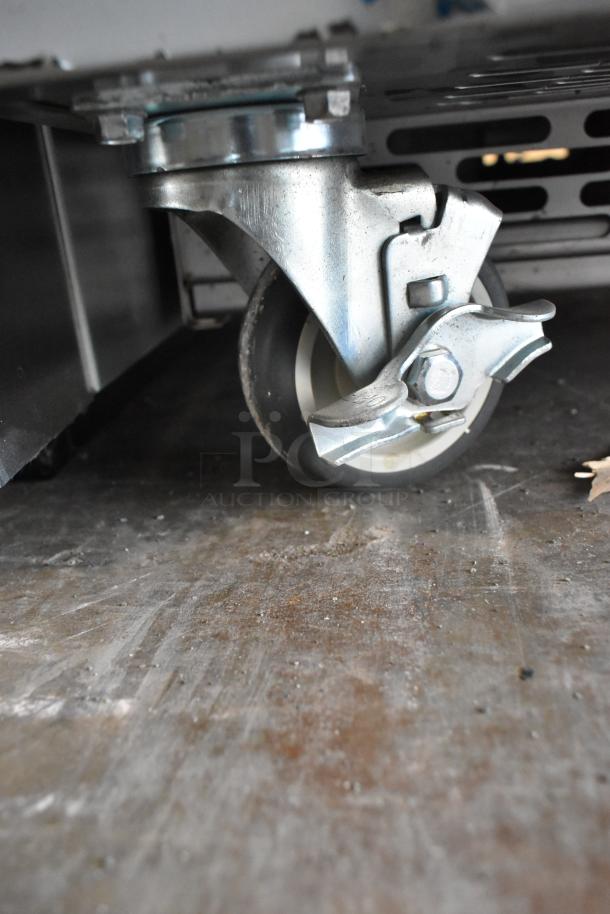 Stainless steel caster wheel of 2021 H&K 52473-1 French fry freezer on a commercial surface.