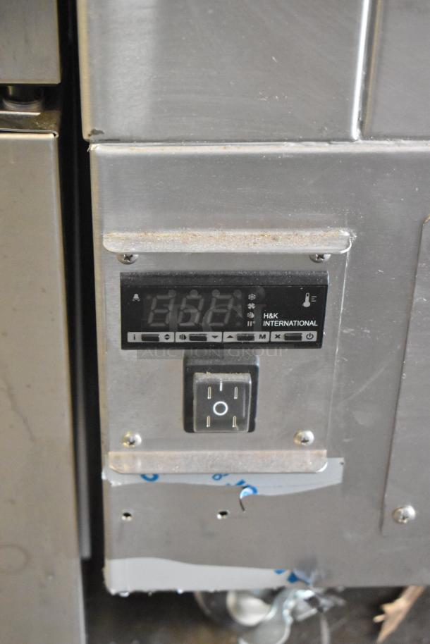 Stainless steel H&K 52473-1 French fry freezer with digital display, control knob, and fry basket holder on casters.