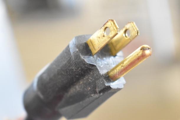 Close-up of a three-prong power plug, part of 2021 H&K Stainless Steel Commercial French Fry Freezer, model 52473-1.