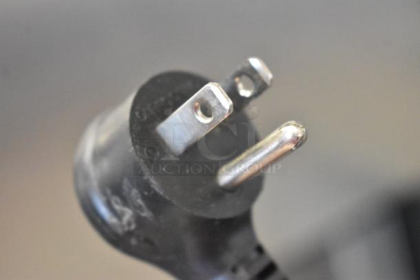 Close-up of a standard three-prong plug for the True T-23F-2-HC-MC commercial freezer, 115V, 1 phase.