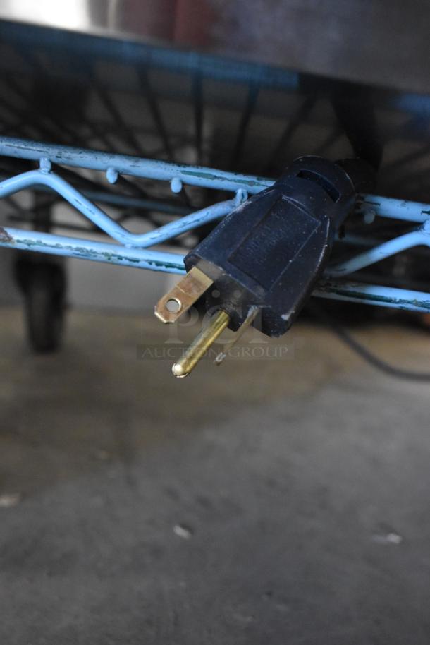 Close-up of a power plug from a 2021 Prince Castle EHB34-2 Commercial 3 Shelf / 12 Pan Holding Bin, 208-240V.