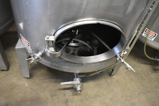 Stainless steel 8.75 BBL beer tank with open hatch, inspection ports, and caution labels. Ideal for commercial brewing.