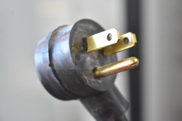 Close-up of a power plug for the Habco SE12 commercial cooler merchandiser, showing a standard three-prong design.