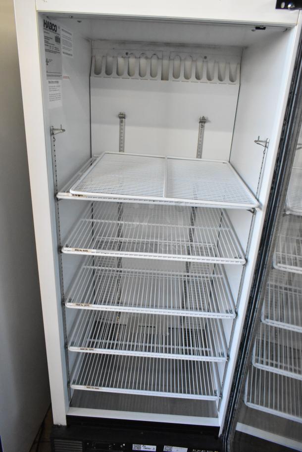 Habco SE12 metal commercial single door reach-in cooler, poly-coated racks, 115 volts, 1 phase, interior tags show model details.