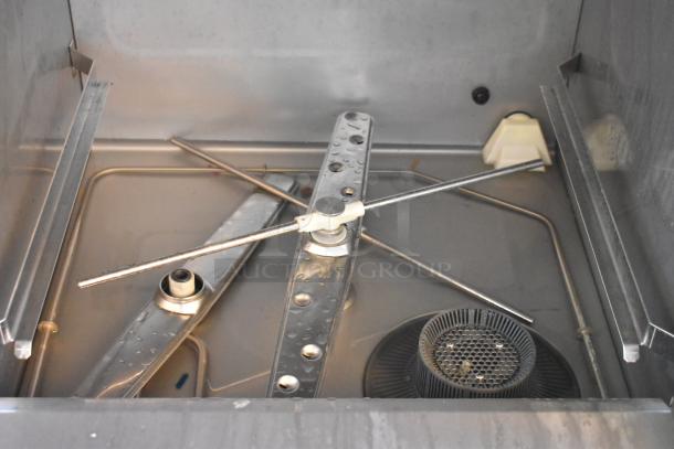 Brand new Moyer Diebel 383HT commercial dishwasher interior, showing stainless steel wash arms and filter.