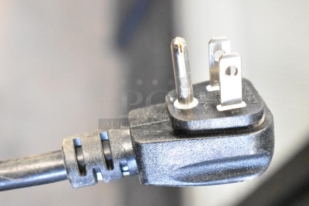 Close-up of a power plug for a 2019 Habco SE18 commercial cooler, showing three prongs and a black plastic casing.