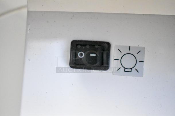 Close-up of a light switch on the 2019 True GDM-41SL-48-HC-LD Commercial Cooler.