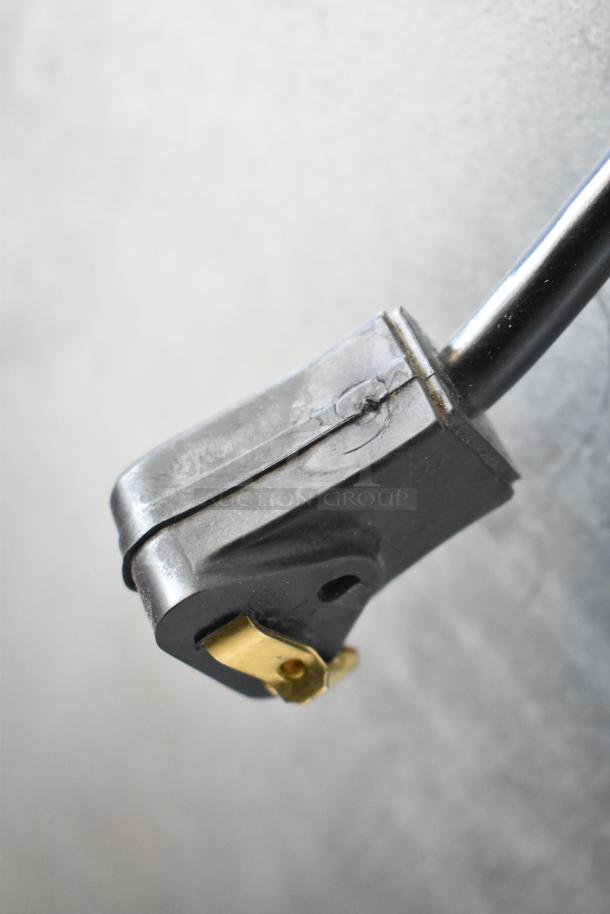 Close-up of a worn power plug for the Habco SE18 cooler, showing signs of use. Black housing and brass prongs visible.