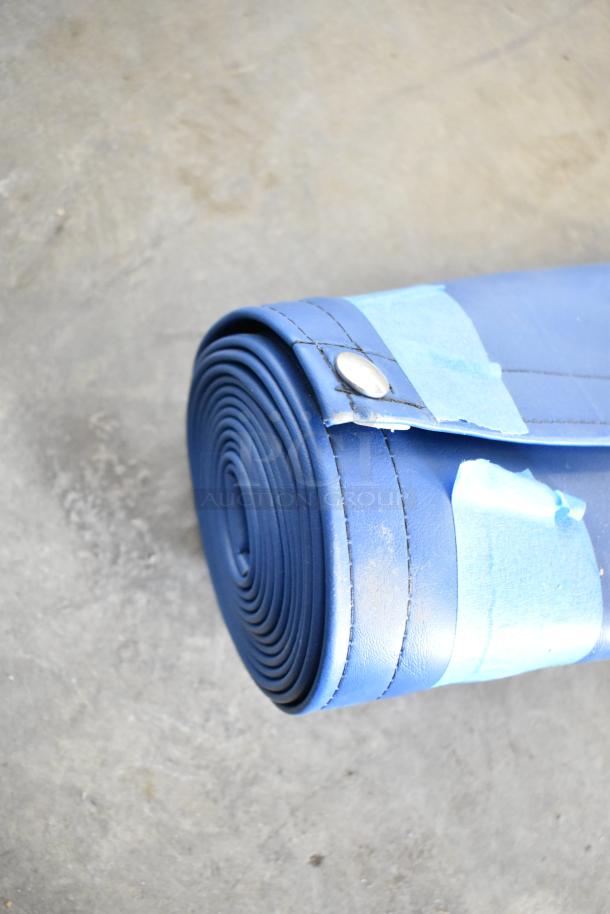 Blue material roll with stitched edges, secured with metal rivets. Slight wear visible. Part of 4-roll auction lot.