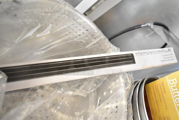 14 new scratch and dent items, including 18" magnetic knife rack, Winco colander, butter roller, and Vollrath skillet.