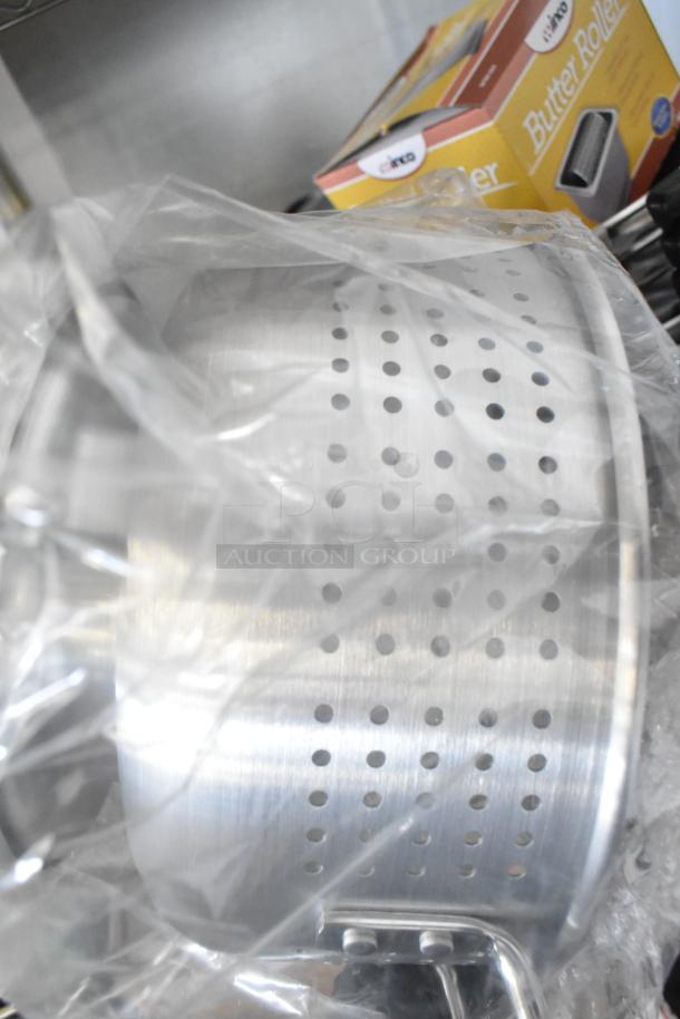 New Winco ALO-8BH colander in plastic wrap, box for Winco SPBR-604 butter roller in background.