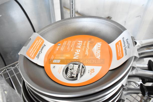 14 brand new scratch and dent items including Vollrath 67810 non-stick fry pans, showcasing retail tags and labels.