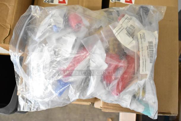 Clear plastic bag containing assorted brand new Marinco connectors and protective caps, various colors and models. Tags visible.
