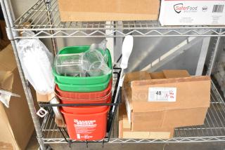18 brand new scratch and dent items, including brushes, red and green poly bins. Items on a metal shelf with boxes.