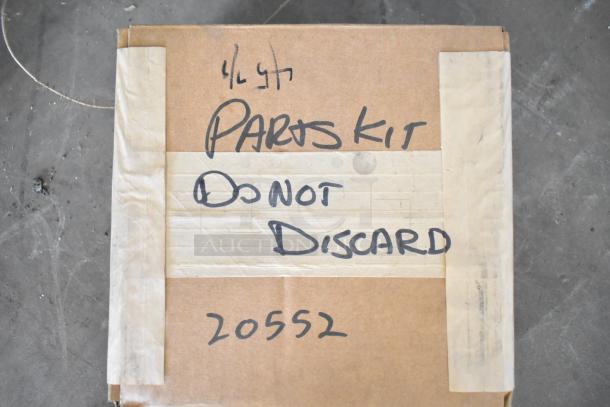 Brown box labeled "Parts Kit, Do Not Discard, 20552." Contains 18 new scratch and dent items, including brushes and poly bins.