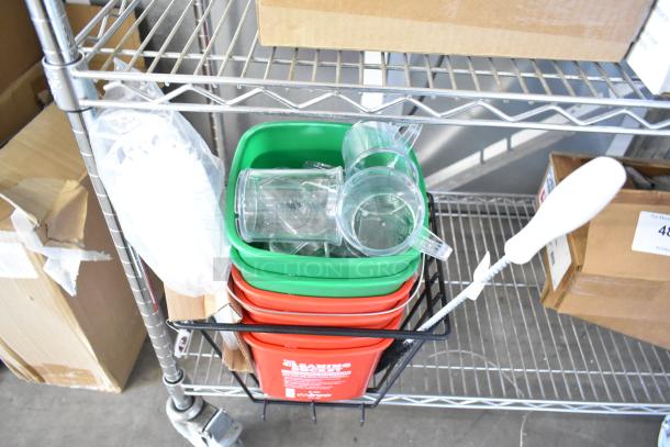 18 new scratch and dent items including assorted cleaning brushes and colored poly bins, stacked on a metal shelf.