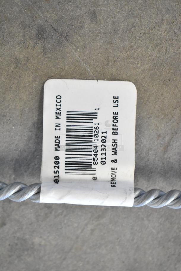 Label on metal wire with barcode, "015200 Made in Mexico," and "Remove & Wash Before Use" text, condition unclear.