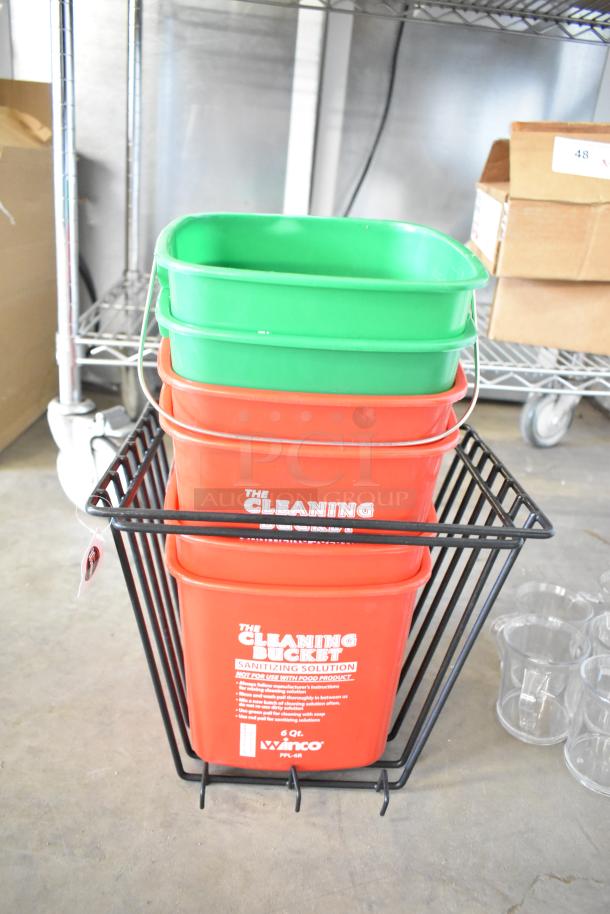 Brand new scratch and dent items including multiple cleaning buckets stacked in a metal rack. Red buckets labeled for sanitizing.