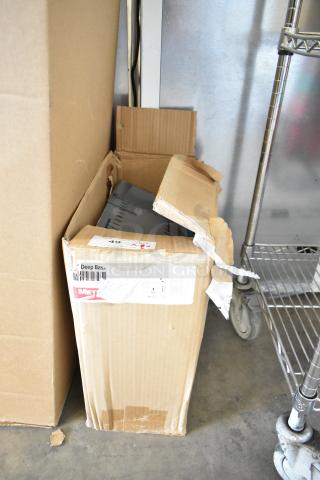 Cardboard box with partial view of items inside, labeled "Metro Deep Basket," indicating scratch and dent condition.