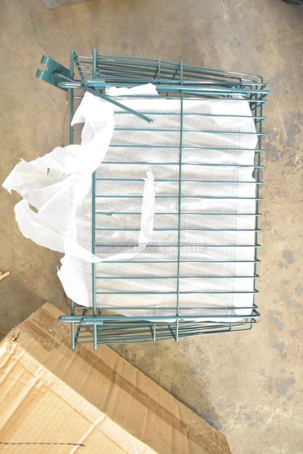 Green metal basket with a scratch and dent, packaged with protective material. Ideal for storage.