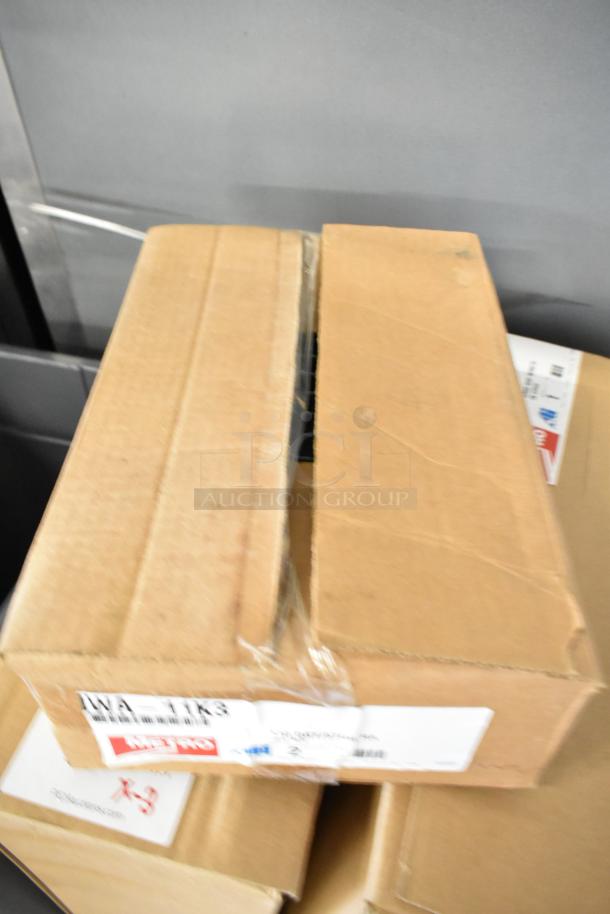Three new items in boxes including Metro IWA-11K3 lid holder and two Metro GS1836K3 grid shelves, minor scratches.