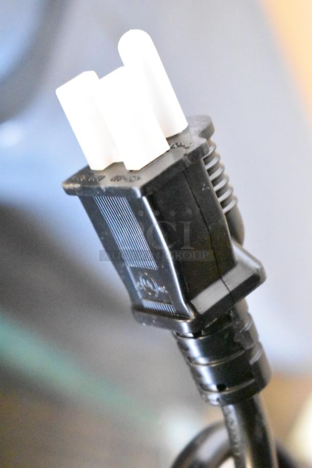 Close-up of a power plug for the Avantco 177W50 stainless steel electric countertop food warmer.