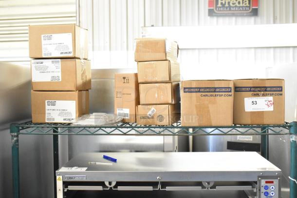 12 brand new scratch and dent items including Carlisle lids, Taylor thermometer. Boxes visible with product labels.