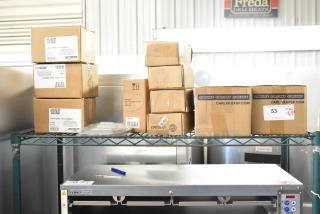 12 brand new scratch and dent items including Carlisle lids, Taylor thermometer. Boxes visible with product labels.