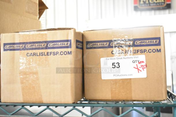 Boxes labeled "Carlisle" with auction tag showing lot 53 for 12 brand new scratch and dent kitchen items.