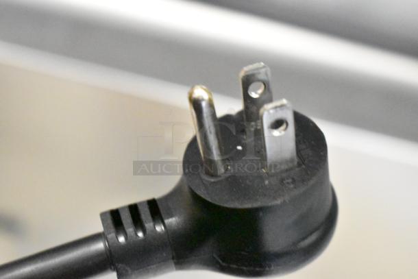 Close-up of a three-prong electrical plug for the 2021 True T-23F-2-HC-MC commercial freezer, 115 Volts, 1 Phase.